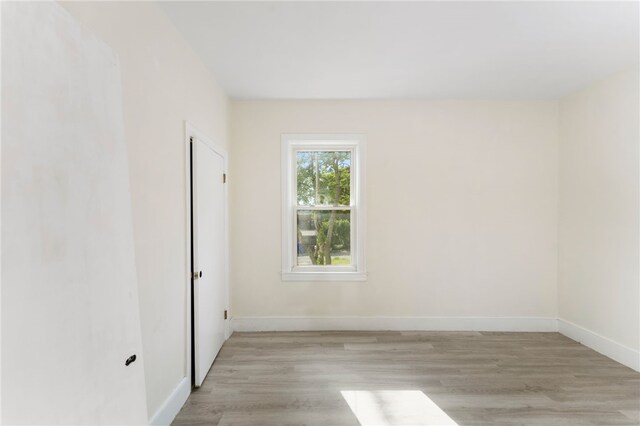 1875 Smith St, North Providence, RI 02911 - empty room with light wood-type flooring and baseboards