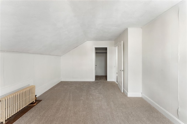 1875 Smith St, North Providence, RI 02911 - bonus room featuring radiator heating unit, carpet flooring, vaulted ceiling, and baseboards