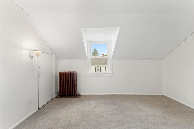 1875 Smith St, North Providence, RI 02911 - additional living space with radiator heating unit, vaulted ceiling, carpet flooring, and baseboards