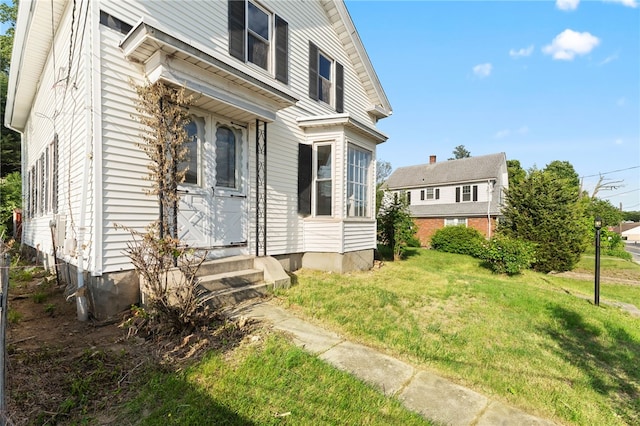 1875 Smith St, North Providence, RI 02911 - view of home's exterior with entry steps and a lawn