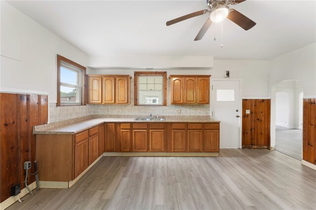 1875 Smith St, North Providence, RI 02911 - kitchen featuring light wood-style floors, brown cabinetry, light countertops, and decorative backsplash