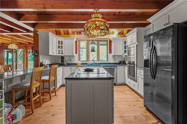 94 S Shore Rd, Burrillville, RI 02859 - kitchen with black appliances, wood ceiling with exposed beams, glass insert cabinets, decorative backsplash, and a center island