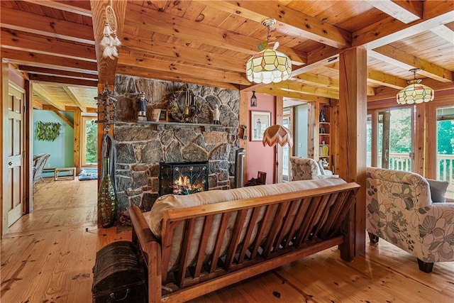 94 S Shore Rd, Burrillville, RI 02859 - living room with hardwood / wood-style flooring, wooden ceiling with exposed beams, healthy amount of natural light, and a fireplace