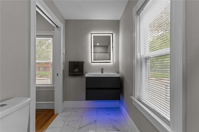 36 Ruth Ave, East Providence, RI 02916 - bathroom with marble finish flooring, toilet, vanity, and baseboards