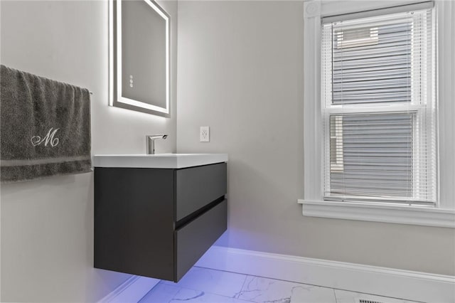 36 Ruth Ave, East Providence, RI 02916 - bathroom featuring marble look tiles, vanity, and baseboards