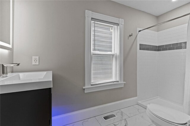 36 Ruth Ave, East Providence, RI 02916 - bathroom with marble finish flooring, vanity, a tile shower, and baseboards