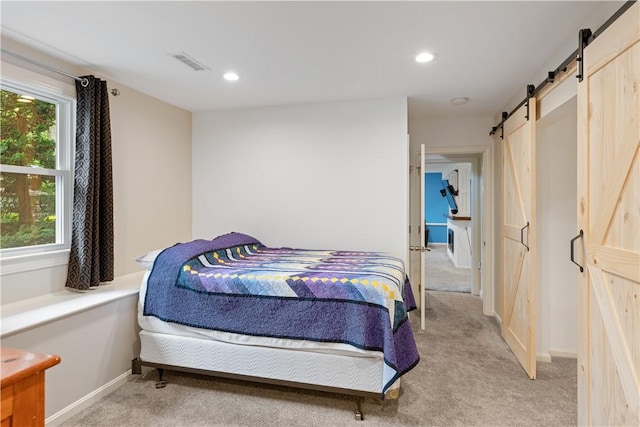 101 Huckleberry Rd, North Kingstown, RI 02852 - bedroom with a barn door, light colored carpet, recessed lighting, and baseboards
