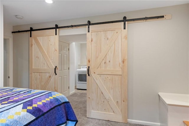 101 Huckleberry Rd, North Kingstown, RI 02852 - bedroom featuring washer / dryer, a barn door, light colored carpet, and baseboards