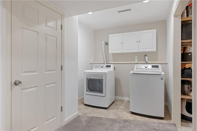 101 Huckleberry Rd, North Kingstown, RI 02852 - laundry area with washing machine and clothes dryer, cabinet space, baseboards, and light tile patterned flooring
