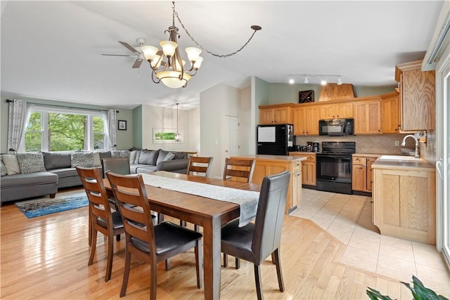 101 Huckleberry Rd, North Kingstown, RI 02852 - dining area with lofted ceiling, a chandelier, rail lighting, and light wood finished floors