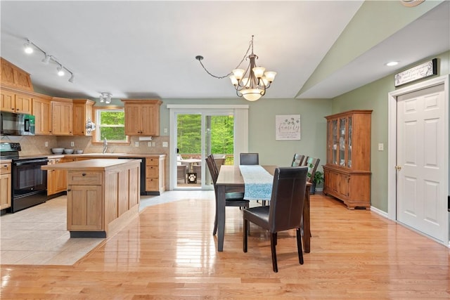 101 Huckleberry Rd, North Kingstown, RI 02852 - dining room with a chandelier, light wood-style floors, vaulted ceiling, and rail lighting