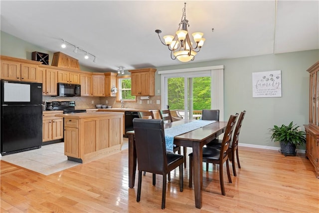 101 Huckleberry Rd, North Kingstown, RI 02852 - dining area featuring a chandelier, rail lighting, light wood-type flooring, baseboards, and vaulted ceiling