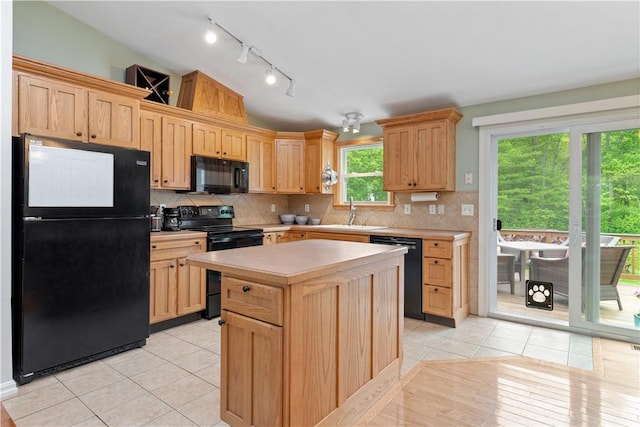 101 Huckleberry Rd, North Kingstown, RI 02852 - kitchen featuring black appliances, a sink, rail lighting, light countertops, and light tile patterned floors