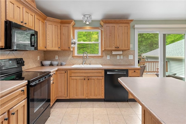 101 Huckleberry Rd, North Kingstown, RI 02852 - kitchen with black appliances, a sink, light countertops, decorative backsplash, and light tile patterned floors