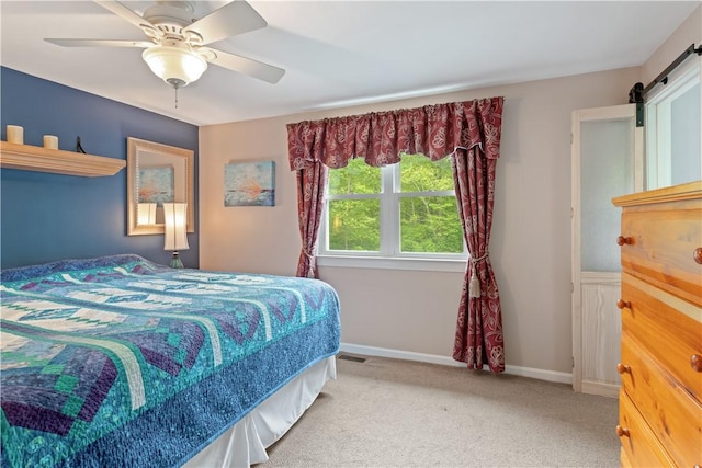 101 Huckleberry Rd, North Kingstown, RI 02852 - carpeted bedroom featuring a barn door, ceiling fan, and baseboards