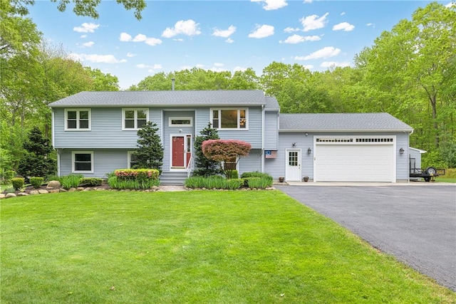 101 Huckleberry Rd, North Kingstown, RI 02852 - raised ranch featuring an attached garage, a front yard, and driveway