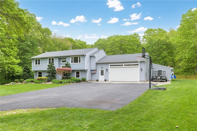 101 Huckleberry Rd, North Kingstown, RI 02852 - view of front of house with asphalt driveway, a front yard, a garage, and view of wooded area