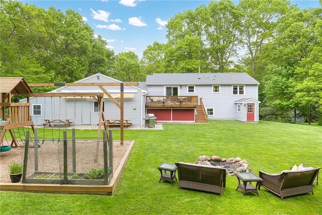 101 Huckleberry Rd, North Kingstown, RI 02852 - back of property with a deck, stairs, a playground, and a yard