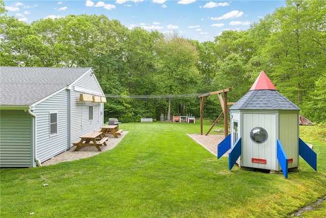 101 Huckleberry Rd, North Kingstown, RI 02852 - view of green lawn with a playground and view of wooded area
