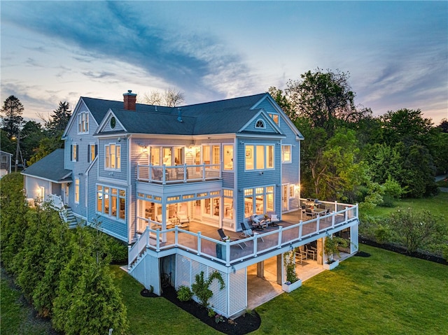 22 Tyler Point Rd, Barrington, RI 02806 - rear view of property featuring a balcony, a chimney, a lawn, a patio, and roof with shingles