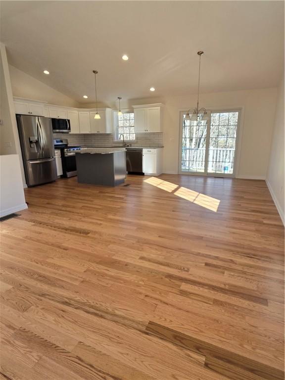 10 Sheffield Rd, Smithfield, RI 02828 - kitchen featuring stainless steel appliances, white cabinetry, a chandelier, light wood finished floors, and recessed lighting