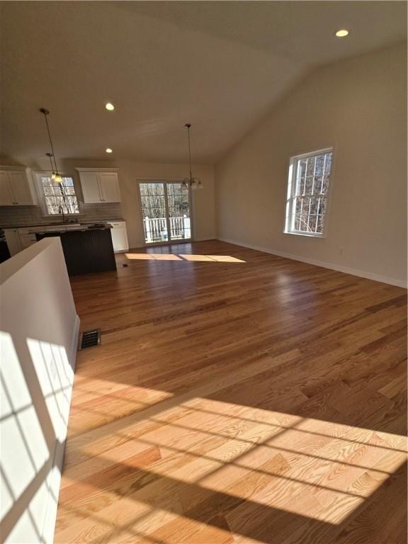 10 Sheffield Rd, Smithfield, RI 02828 - unfurnished living room with a chandelier, recessed lighting, light wood-style flooring, and vaulted ceiling