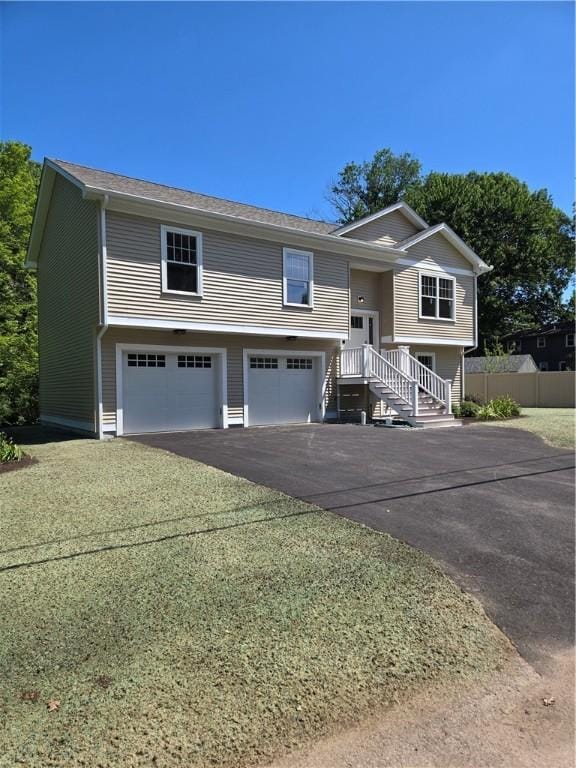 10 Sheffield Rd, Smithfield, RI 02828 - bi-level home featuring an attached garage and asphalt driveway