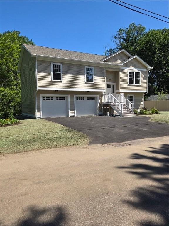 10 Sheffield Rd, Smithfield, RI 02828 - split foyer home with an attached garage and asphalt driveway