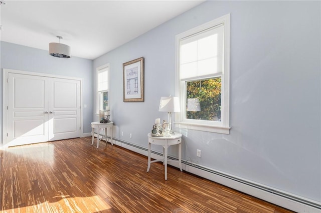 85 Frigate St, Jamestown, RI 02832 - foyer entrance featuring baseboard heating, wood finished floors, and baseboards