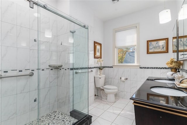 85 Frigate St, Jamestown, RI 02832 - bathroom featuring tile walls, double vanity, a stall shower, and toilet