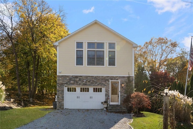 85 Frigate St, Jamestown, RI 02832 - view of side of property with stone siding, gravel driveway, a garage, entry steps, and a lawn