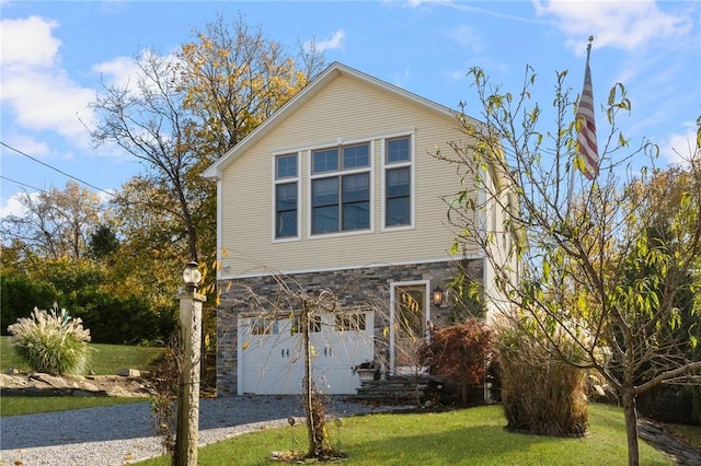 85 Frigate St, Jamestown, RI 02832 - view of front facade with stone siding, gravel driveway, a front yard, and a garage