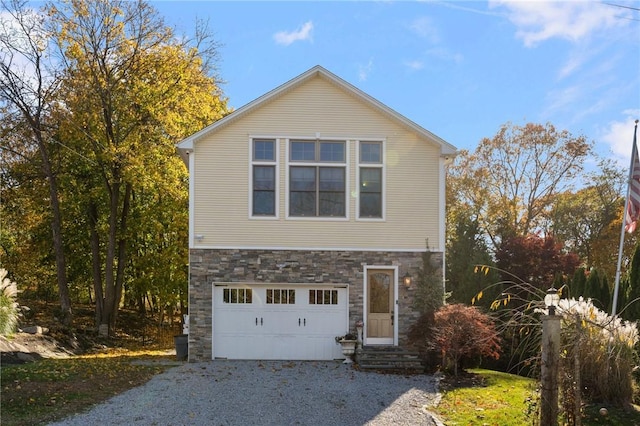 85 Frigate St, Jamestown, RI 02832 - view of side of home featuring stone siding, gravel driveway, entry steps, and a garage