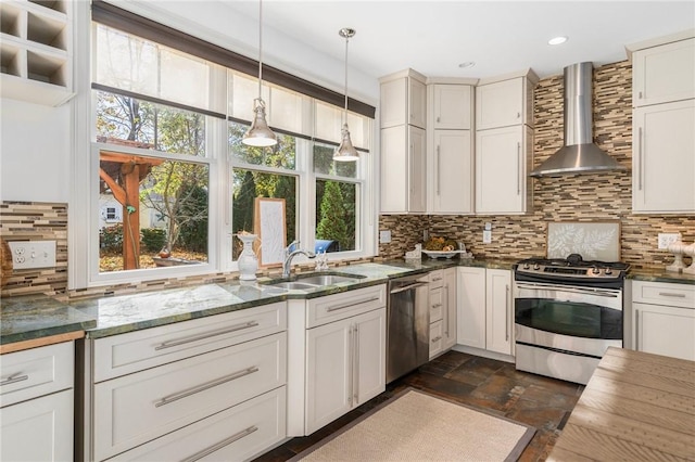 85 Frigate St, Jamestown, RI 02832 - kitchen featuring appliances with stainless steel finishes, wall chimney exhaust hood, tasteful backsplash, a sink, and pendant lighting