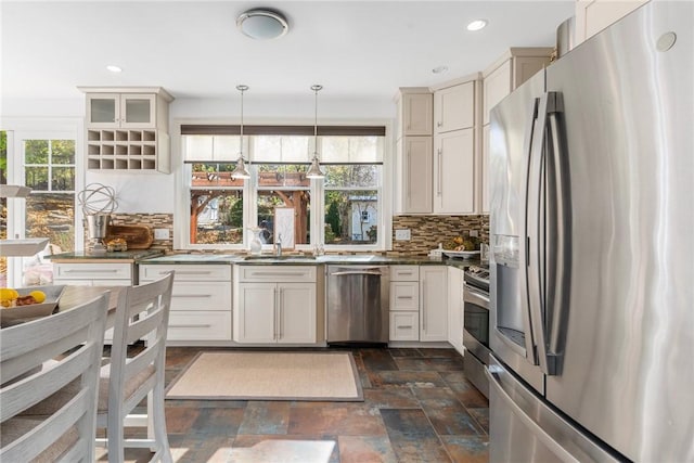 85 Frigate St, Jamestown, RI 02832 - kitchen with stainless steel appliances, a sink, dark stone finish floors, tasteful backsplash, and dark countertops
