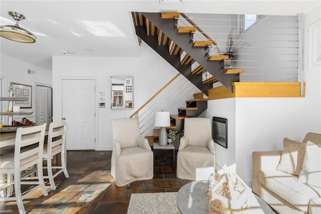 85 Frigate St, Jamestown, RI 02832 - living area with stairway, stone finish flooring, and baseboards