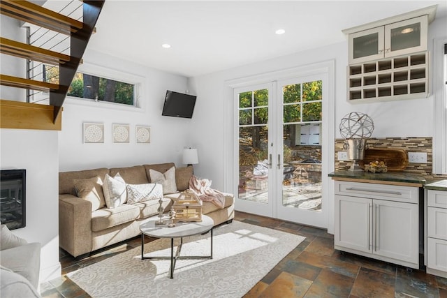 85 Frigate St, Jamestown, RI 02832 - living room with stone tile floors, recessed lighting, french doors, and a glass covered fireplace