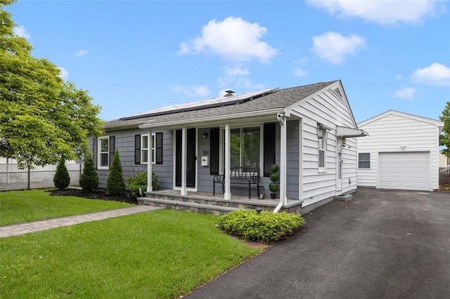 150 Memorial Dr, Pawtucket, RI 02860 - ranch-style home with a porch, an outdoor structure, roof mounted solar panels, and asphalt driveway