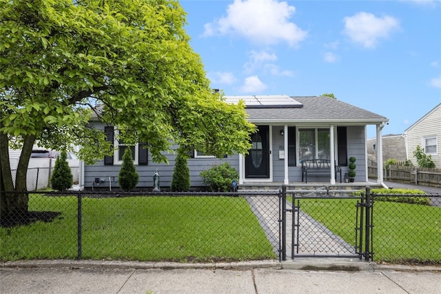 150 Memorial Dr, Pawtucket, RI 02860 - view of front facade featuring covered porch, a fenced front yard, a gate, roof mounted solar panels, and a shingled roof