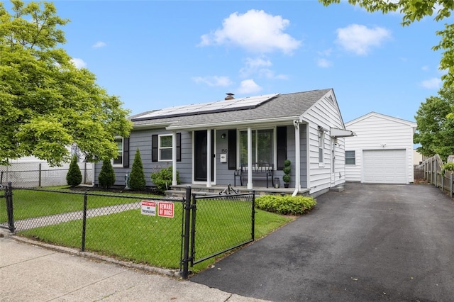 150 Memorial Dr, Pawtucket, RI 02860 - single story home featuring a porch, a fenced front yard, asphalt driveway, an outdoor structure, and roof mounted solar panels
