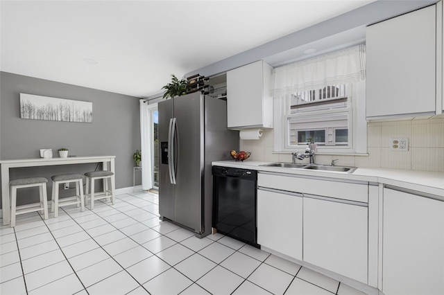 150 Memorial Dr, Pawtucket, RI 02860 - kitchen featuring black dishwasher, light countertops, white cabinetry, tasteful backsplash, and stainless steel fridge