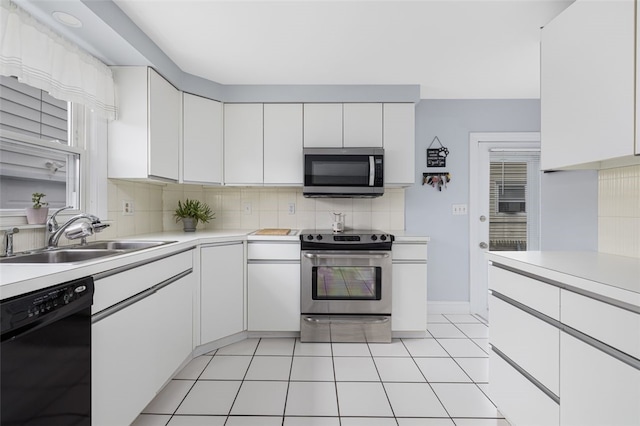 150 Memorial Dr, Pawtucket, RI 02860 - kitchen with appliances with stainless steel finishes, light countertops, tasteful backsplash, and white cabinetry