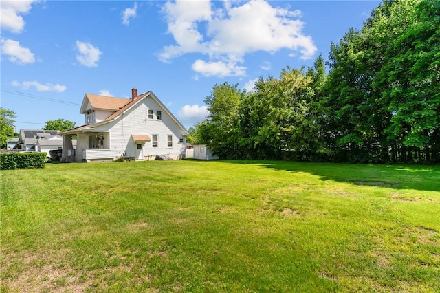 8 Tampa St, West Warwick, RI 02893 - view of side of home featuring a lawn and a chimney