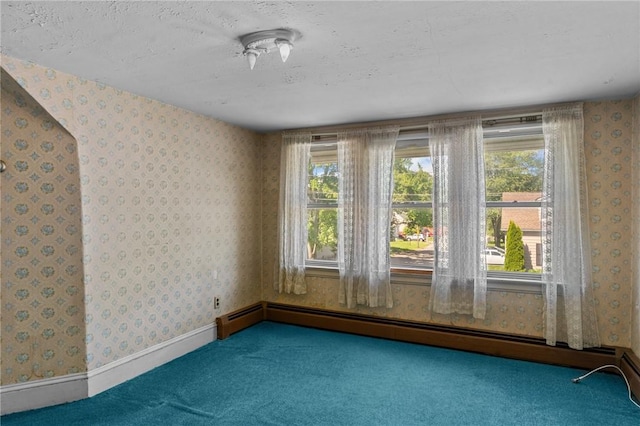 8 Tampa St, West Warwick, RI 02893 - carpeted empty room with a baseboard heating unit, wallpapered walls, and plenty of natural light