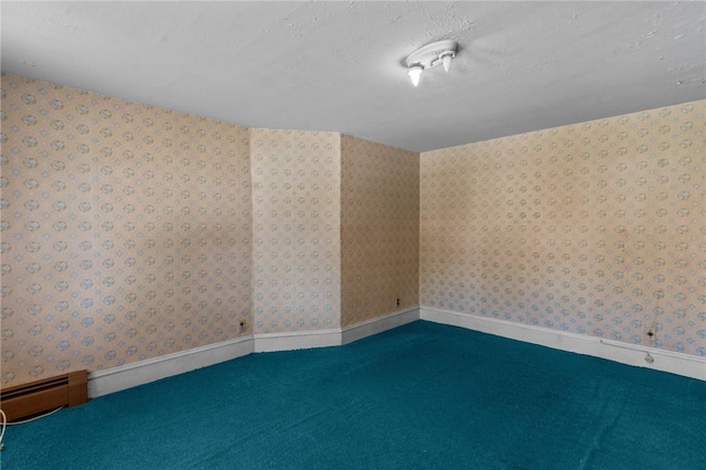 8 Tampa St, West Warwick, RI 02893 - spare room featuring a textured ceiling, wallpapered walls, a baseboard radiator, and carpet floors