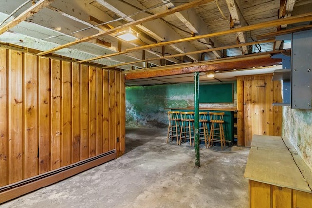 8 Tampa St, West Warwick, RI 02893 - unfinished below grade area featuring baseboard heating and a bar