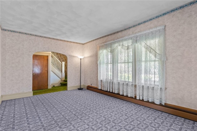 8 Tampa St, West Warwick, RI 02893 - empty room with a baseboard radiator, arched walkways, and carpet