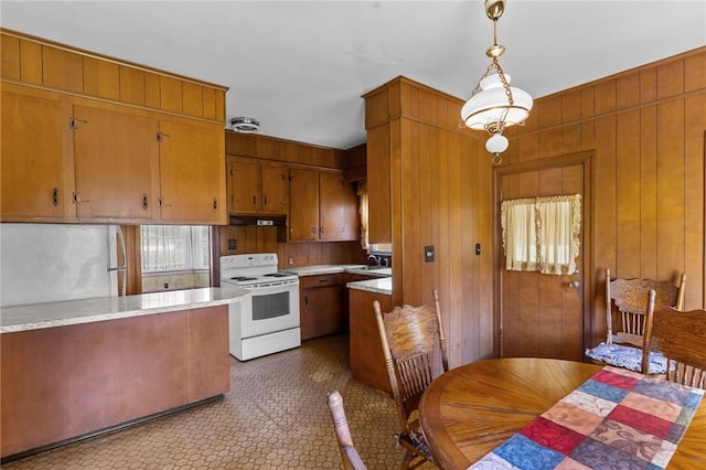 8 Tampa St, West Warwick, RI 02893 - kitchen featuring white electric stove, light countertops, brown cabinets, under cabinet range hood, and a sink