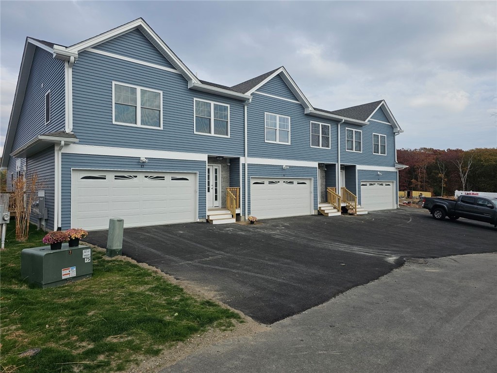 83 Ayda Rose Ave, West Warwick, RI 02893 - view of front of home featuring an attached garage, driveway, and entry steps