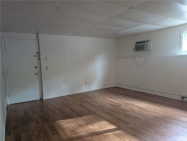 300 Smithfield Rd Unit P2-2, North Providence, RI 02904 - unfurnished room with a wall mounted AC, wood finished floors, baseboards, and a paneled ceiling